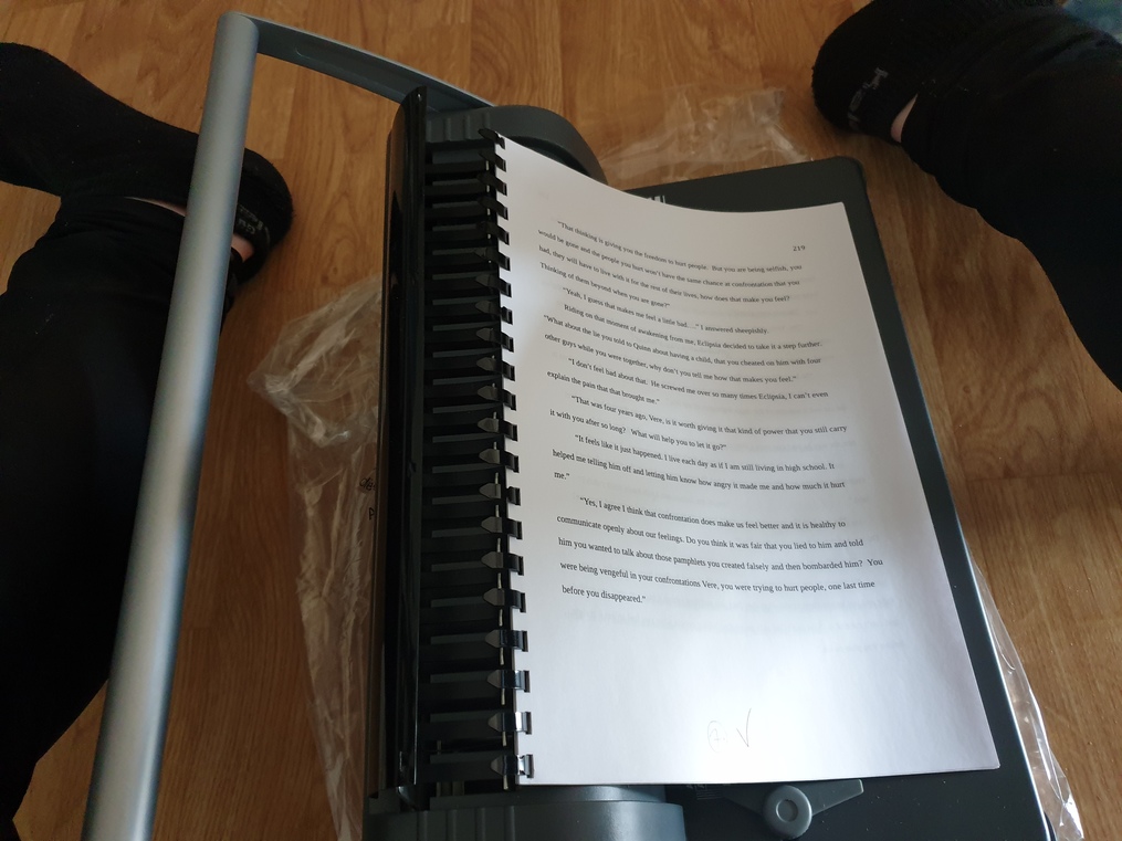 Binding-Machine-perforated-paper-onto-the-plastic-spine-tips-for-binding-your-manuscript-for-editing-and-revision-how-to-print-out-your-book-susan-shiney