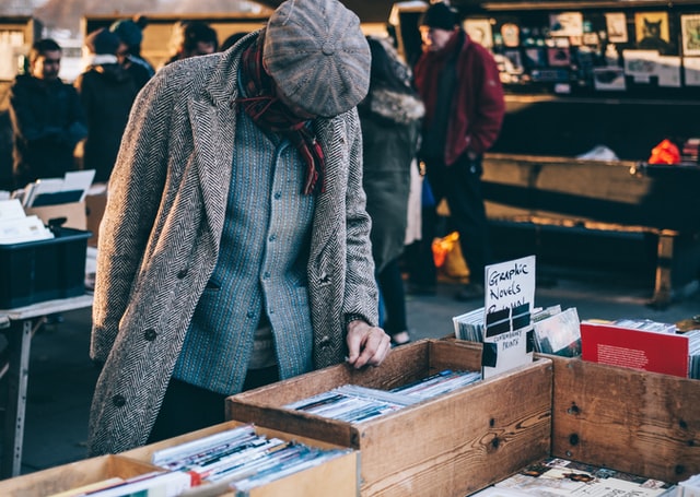 Man-in-a-used-bookstore-how-graphic-novels-help-my-writing-susan-shiney-why-graphic-novels-are-literature-clem-onojeghuo-unsplash